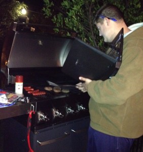 Fat Chris barbecuing and multi-tasking 